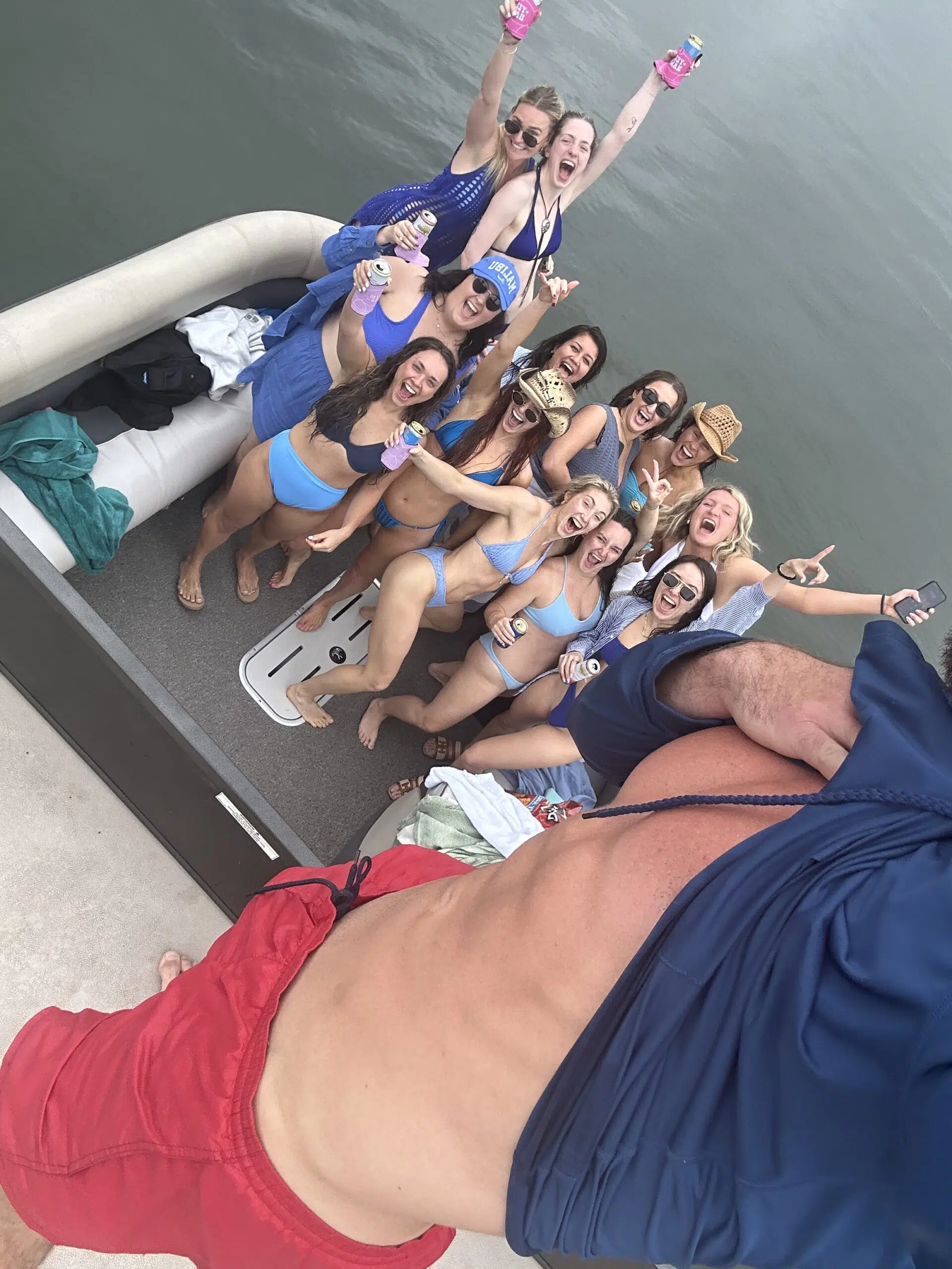 Romantic boat deck decorated with scattered red rose petals on wooden surface.